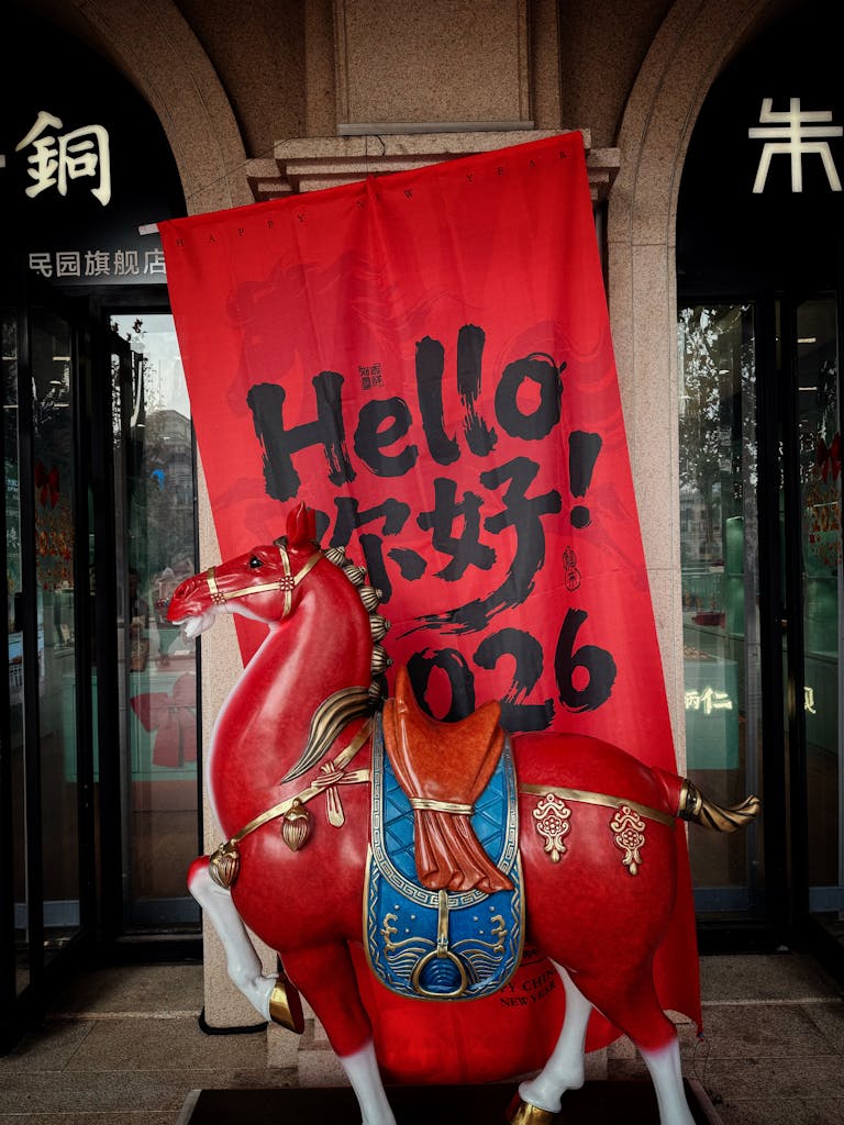 Red horse statue with 'Hello 2026' banner at Chinese New Year exhibit in Tianjin, China.